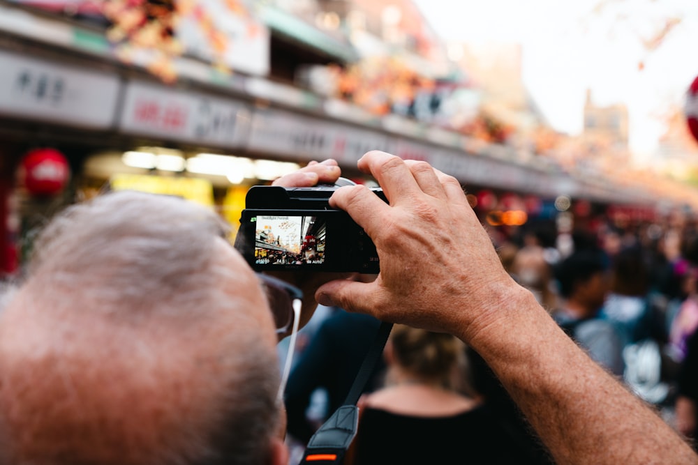 a man taking a picture of a crowd of people