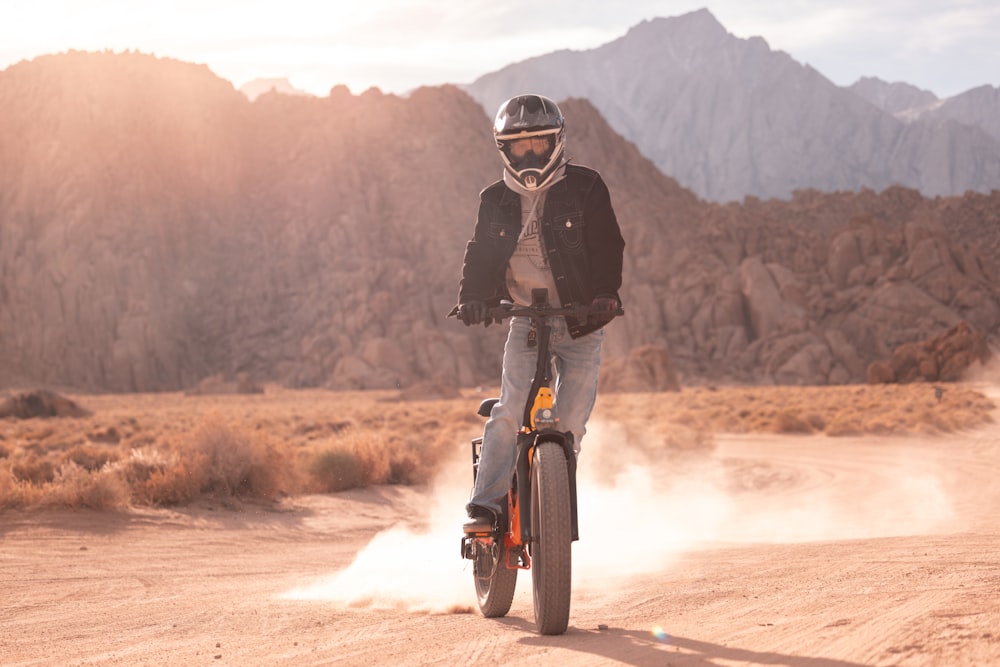 a person riding a bike on a dirt road