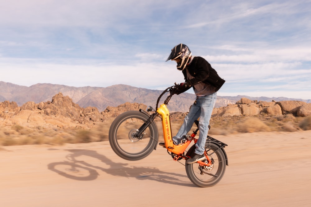 a person riding a bike in the desert
