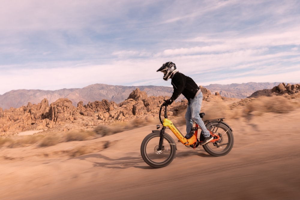 a person riding a bike in the desert