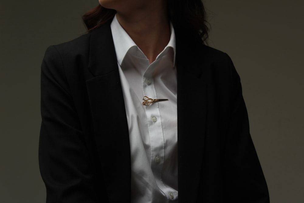 a woman wearing a white shirt and black jacket