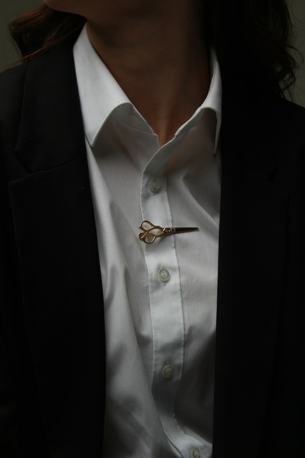 a close up of a person wearing a suit and tie