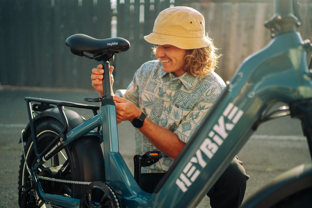 a man sitting next to a blue bike