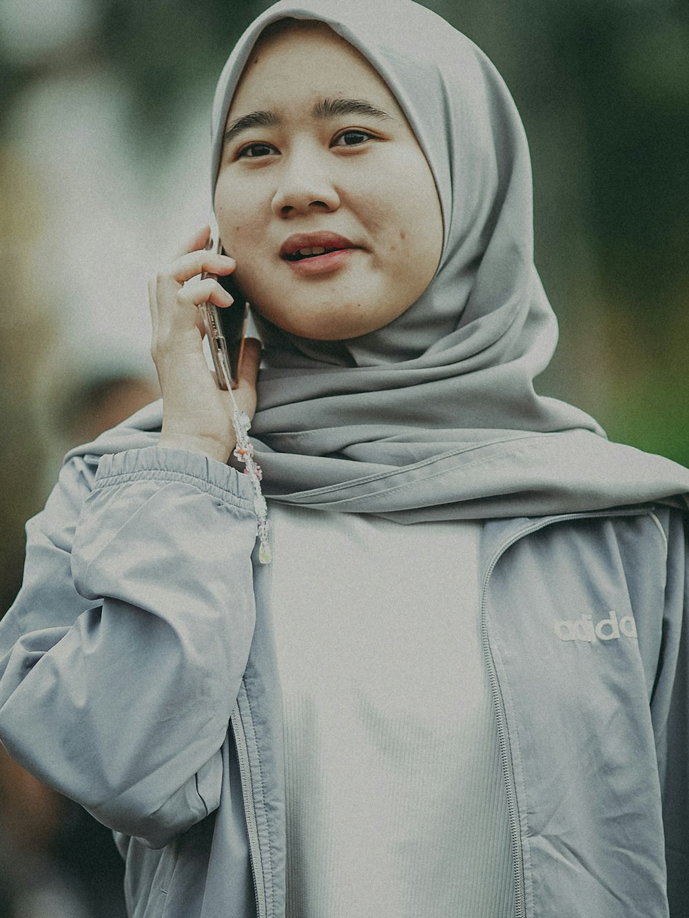 a woman in a hijab talking on a cell phone