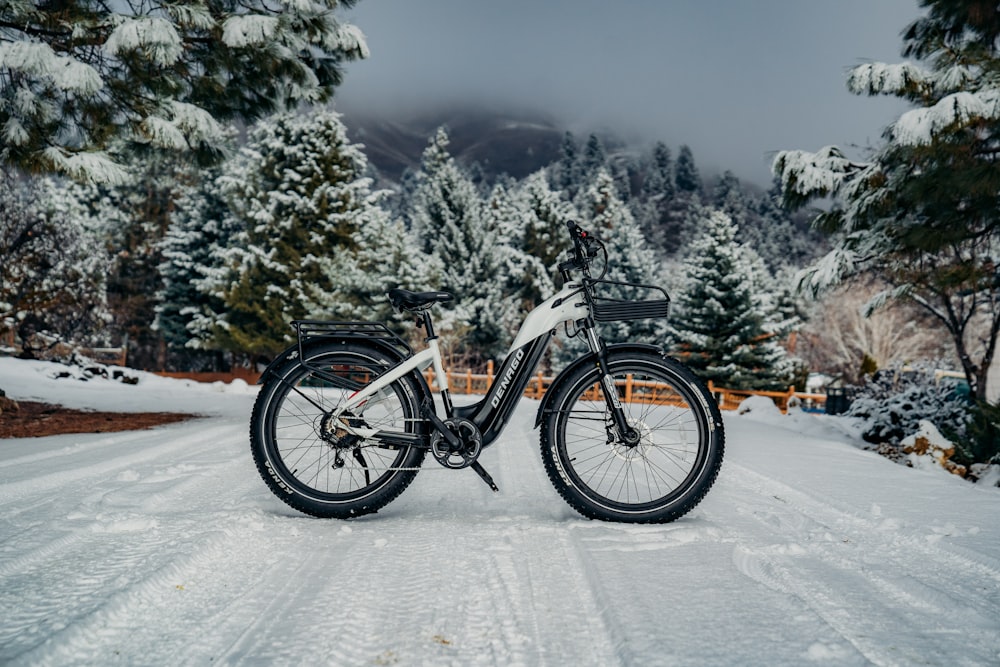 a bicycle is parked on a snowy road