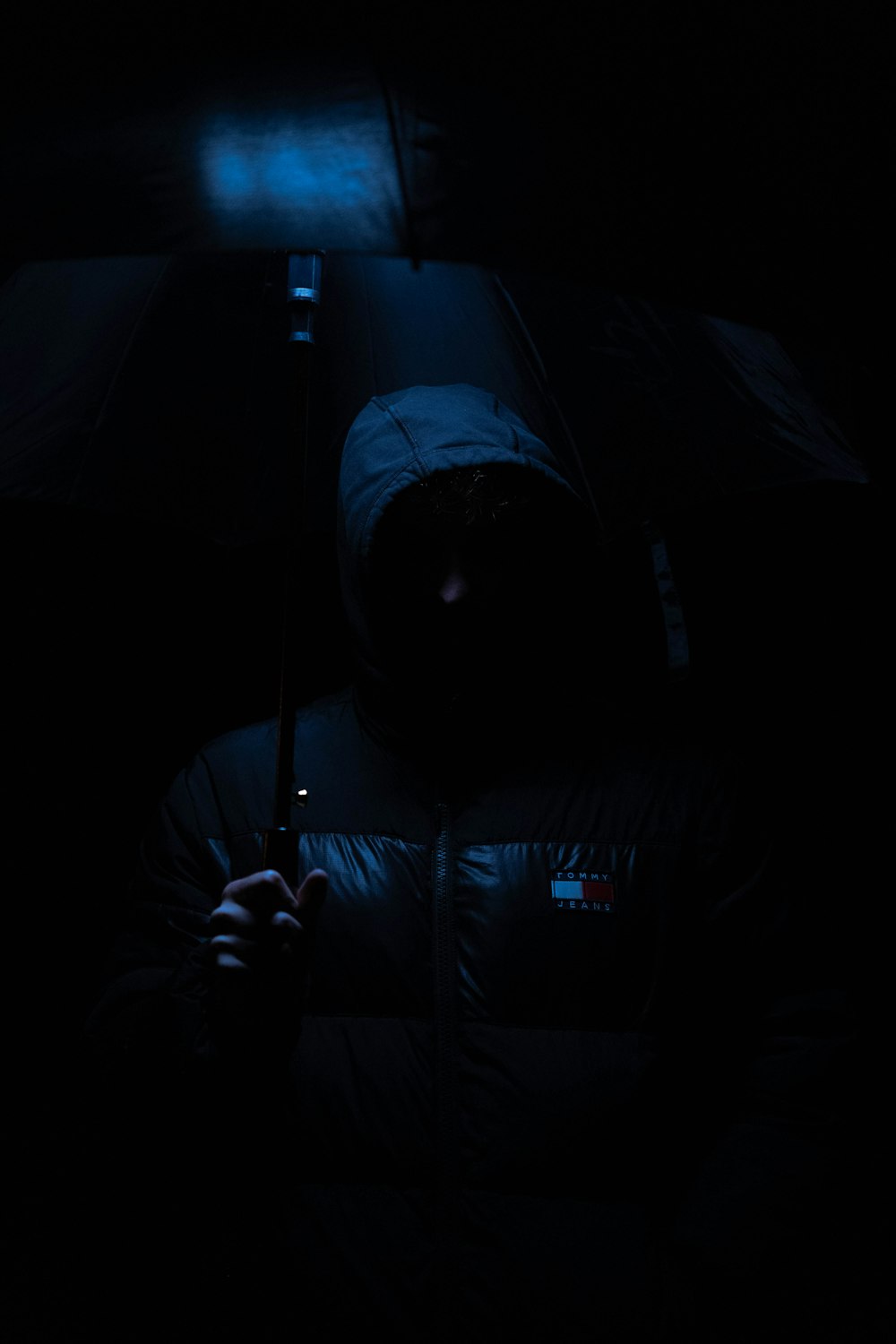 a person holding an umbrella in the dark