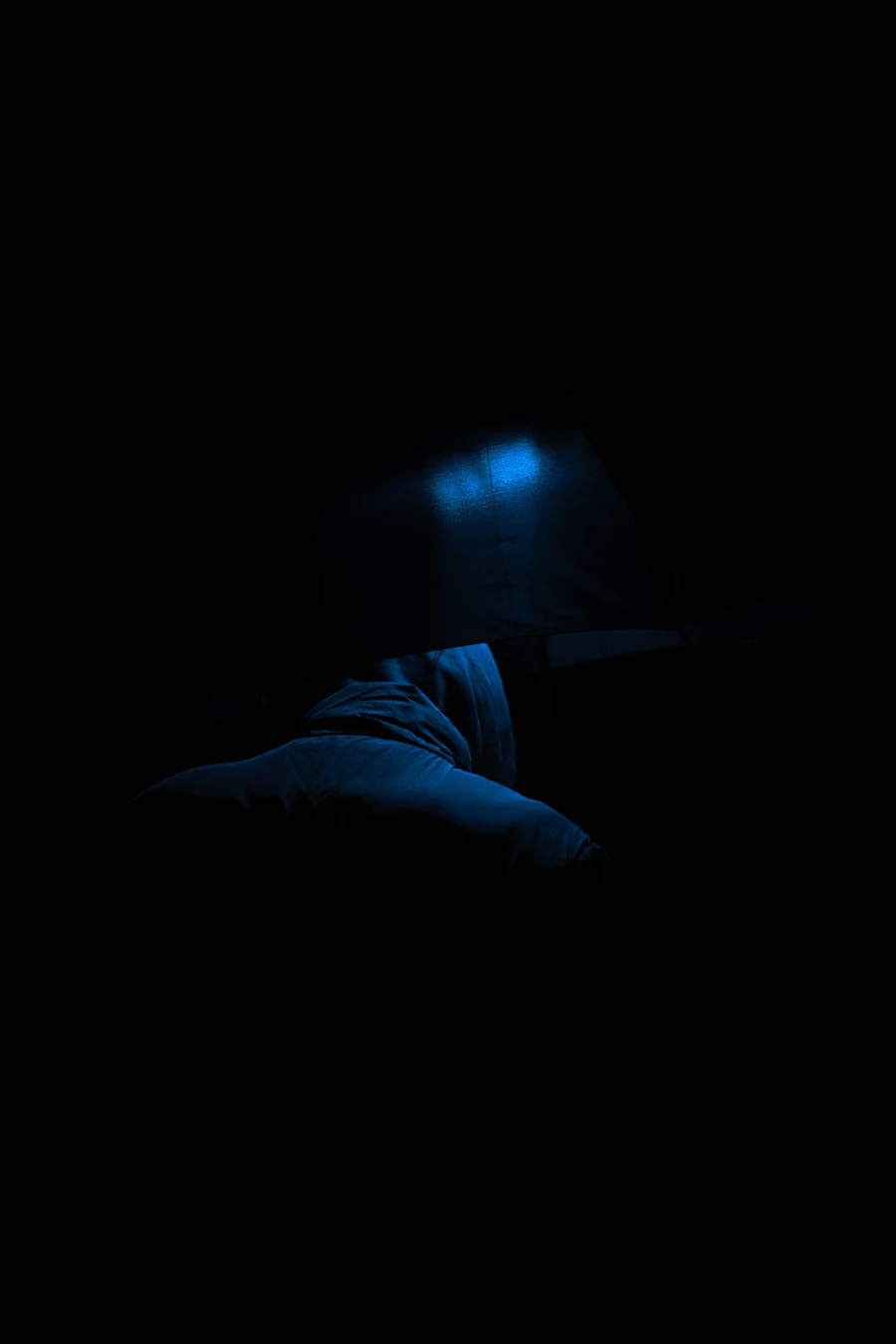 Dark atmospheric bedroom scene with soft ambient light