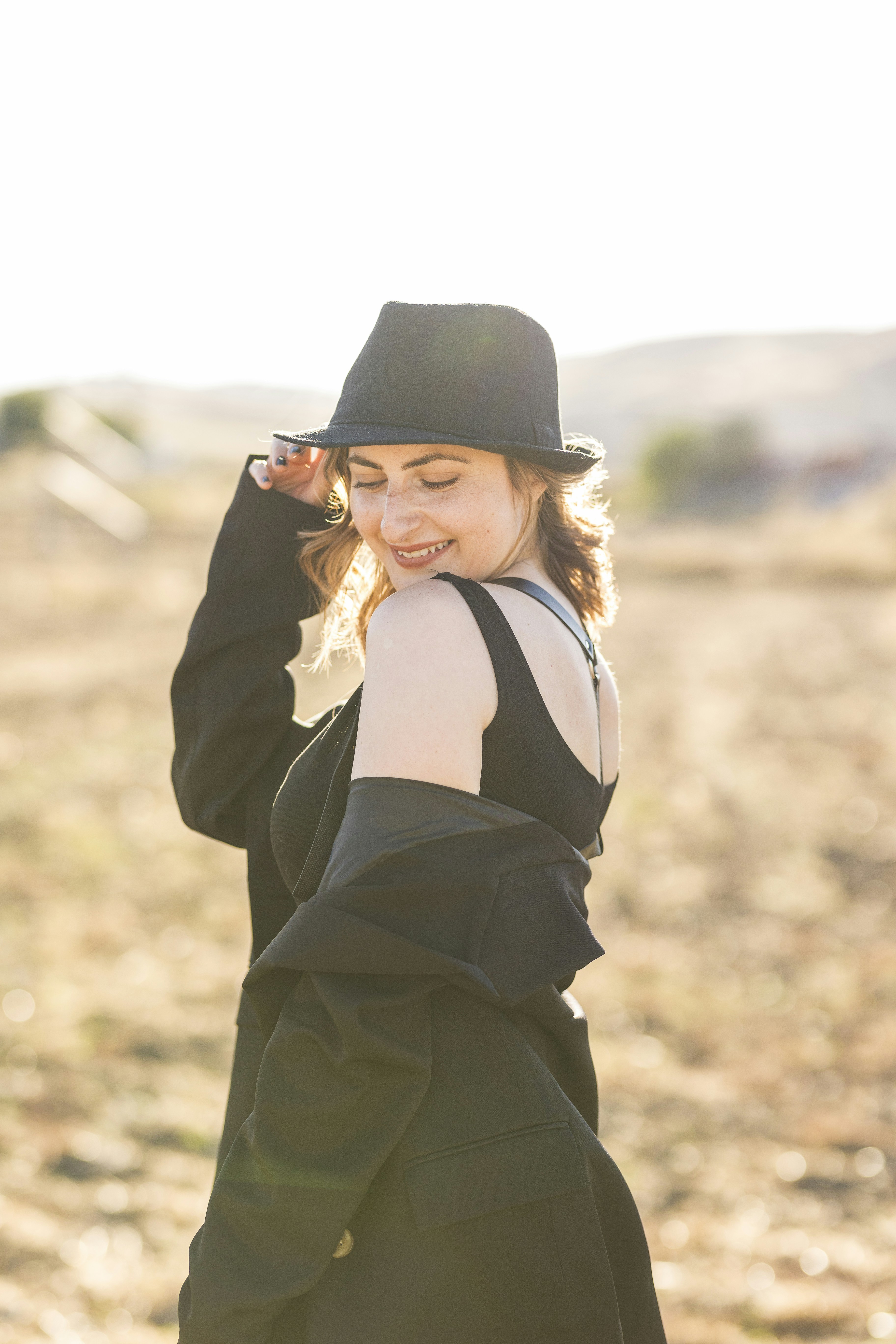 Woman smiling in bright outdoor setting, natural light