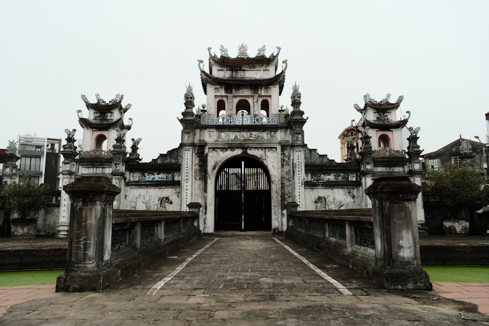 a large building with a gate and a walkway leading to it