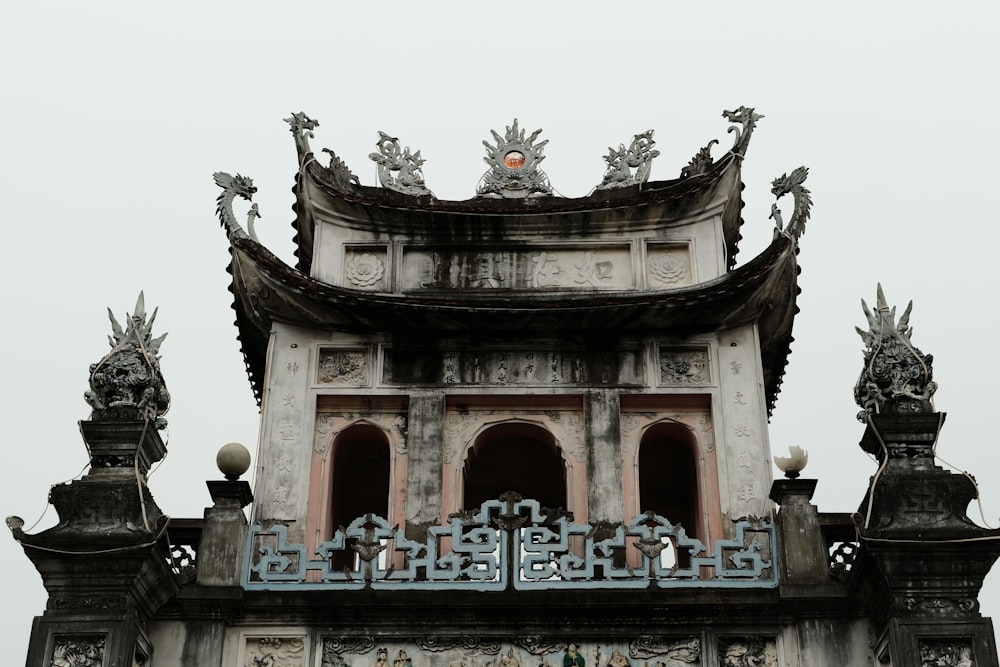 a clock tower with statues on top of it