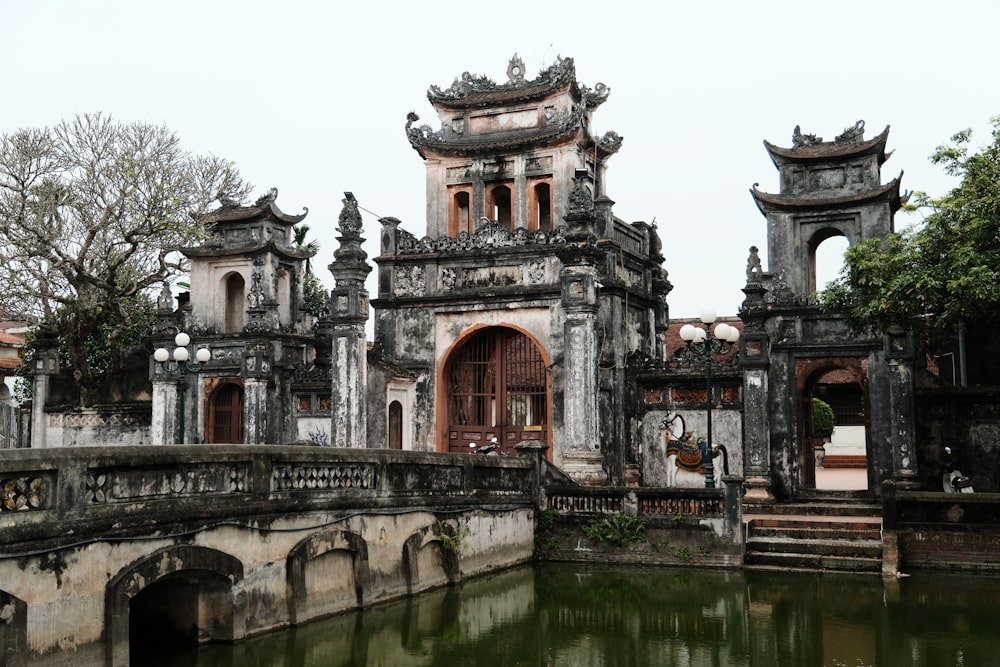 an old building with a pond in front of it