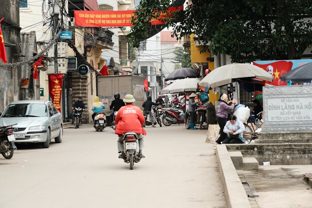 a person riding a motorcycle down a street