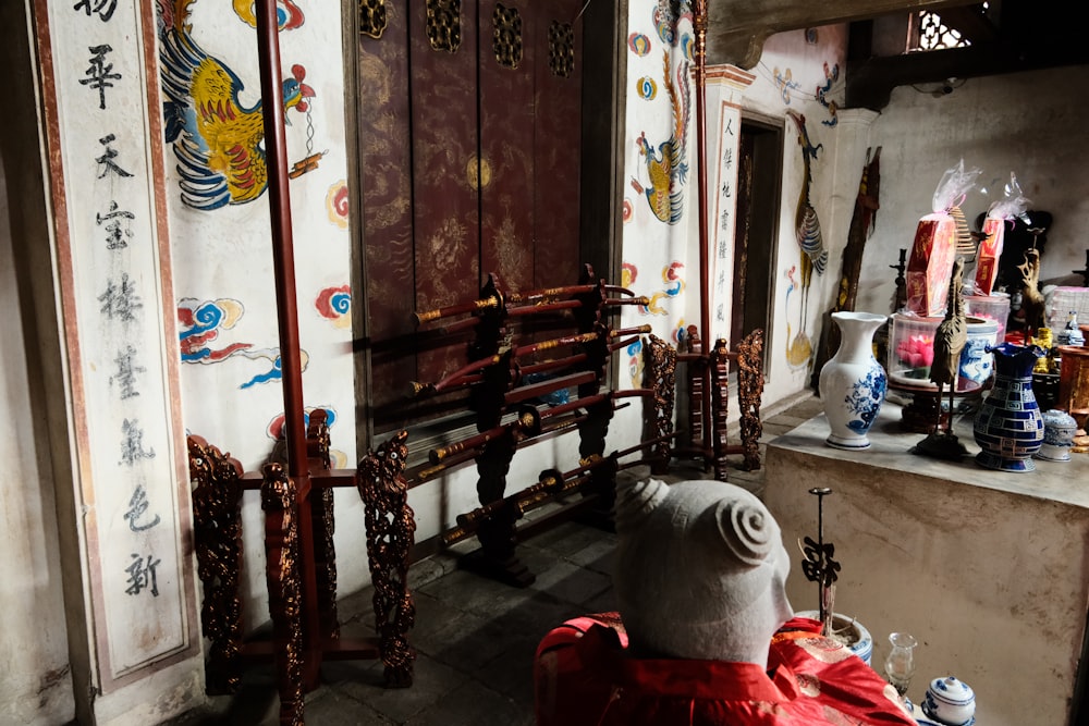 a room with a chair, mirror and oriental decorations