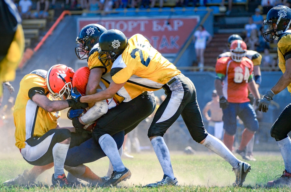 a group of football players playing a game of football