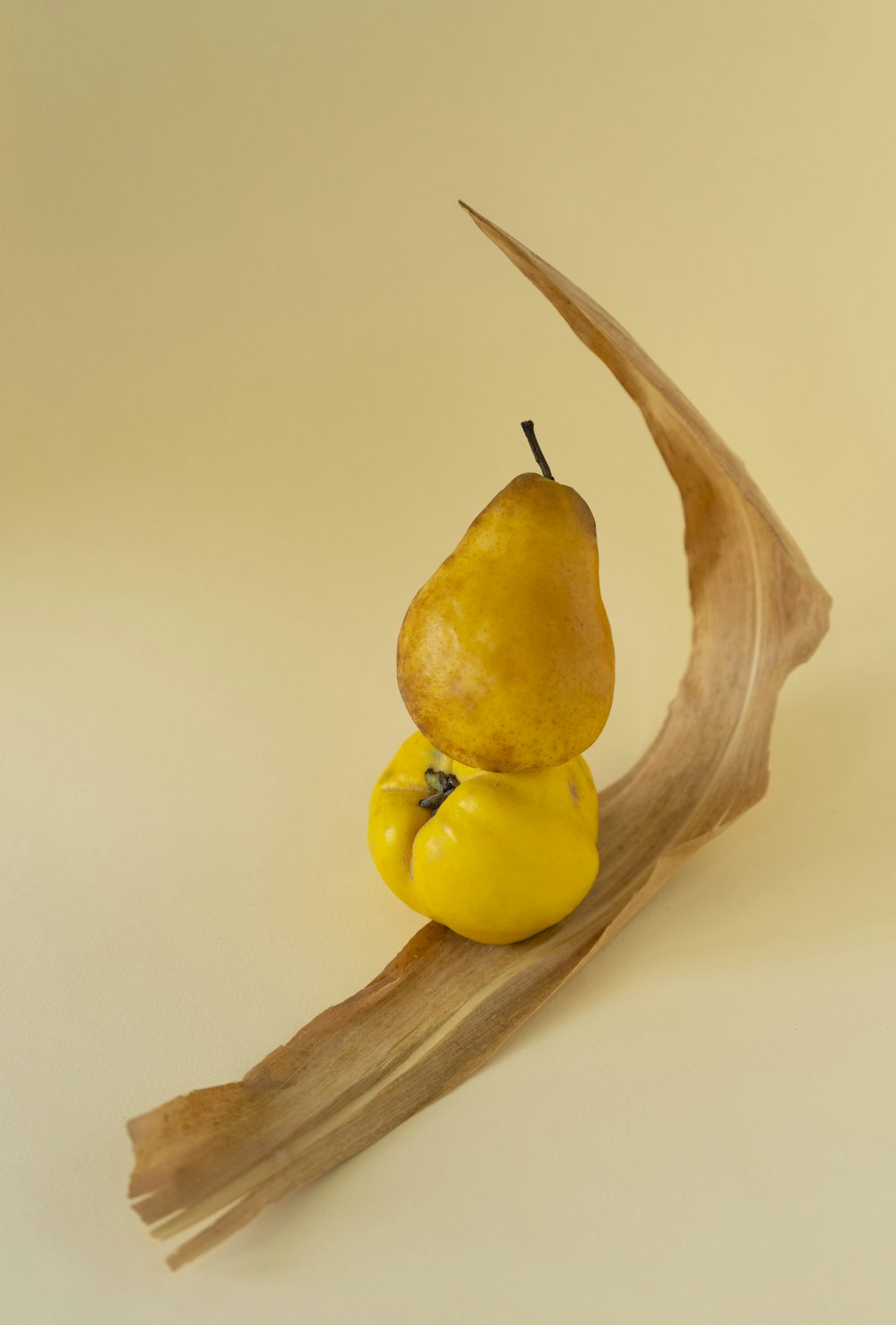 a figurine of a pear sitting on a branch