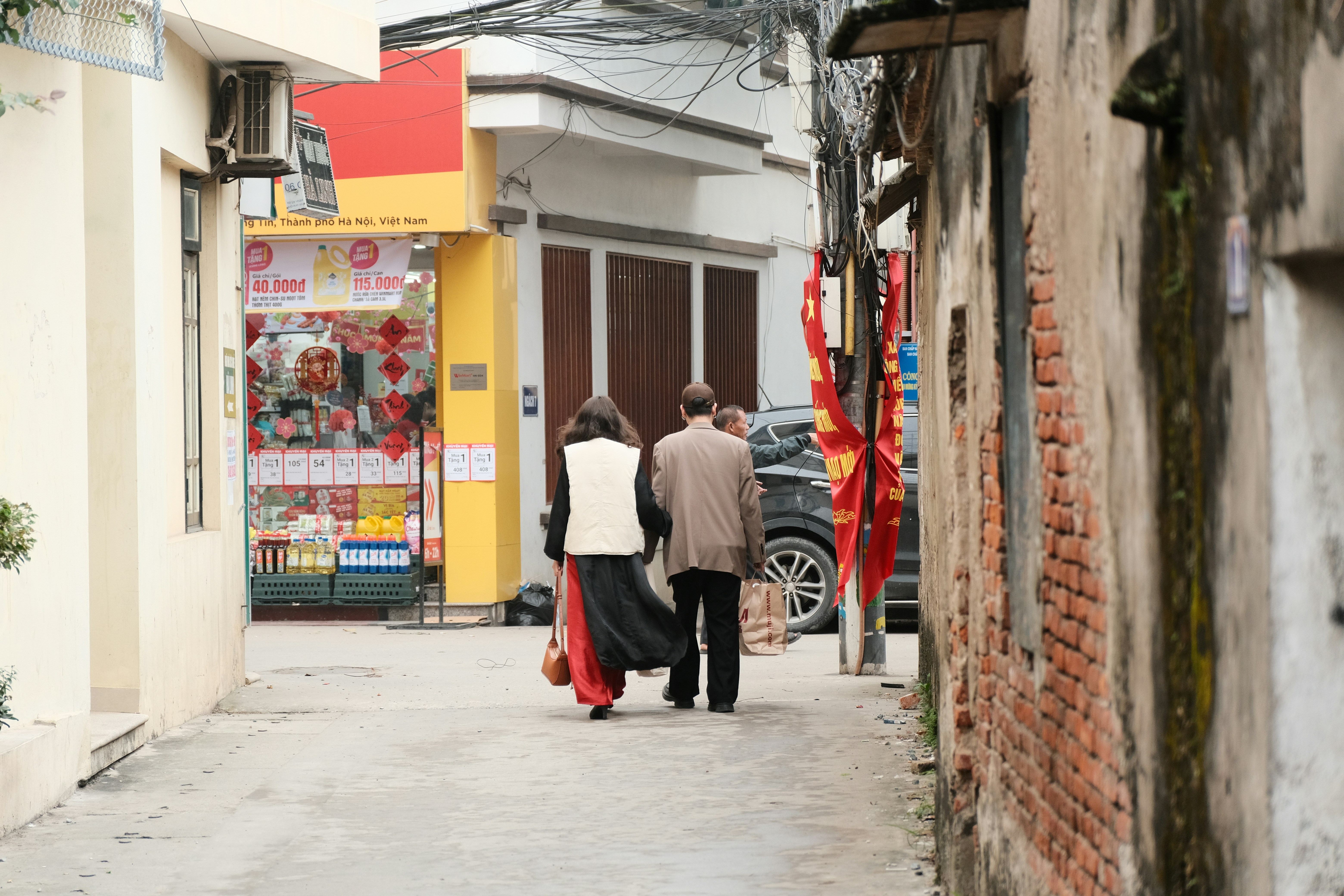 a couple of people that are walking down a street