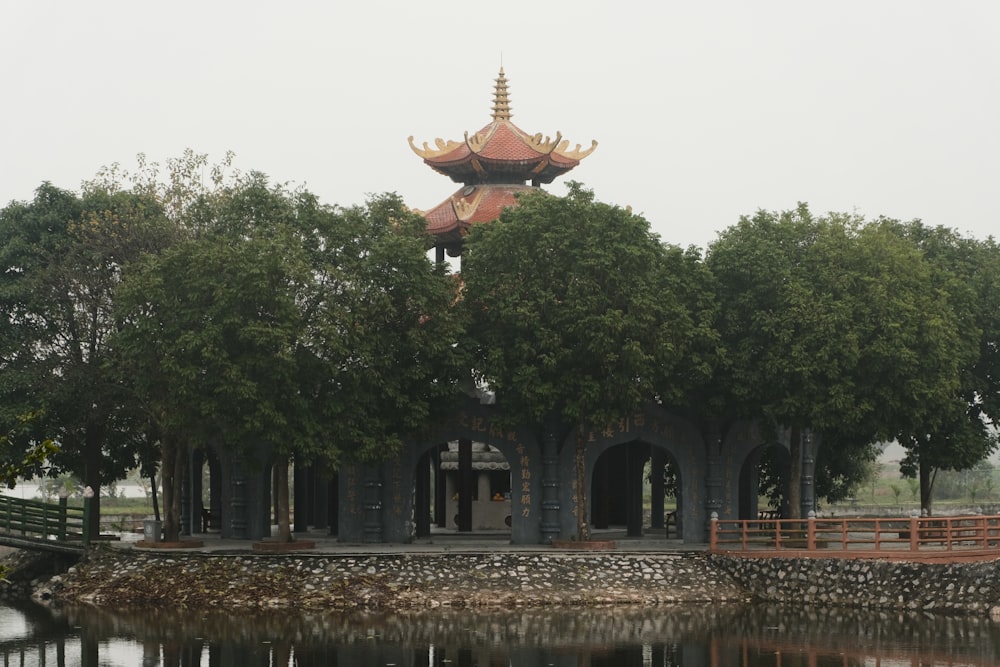 a building with a tower and a bridge over water