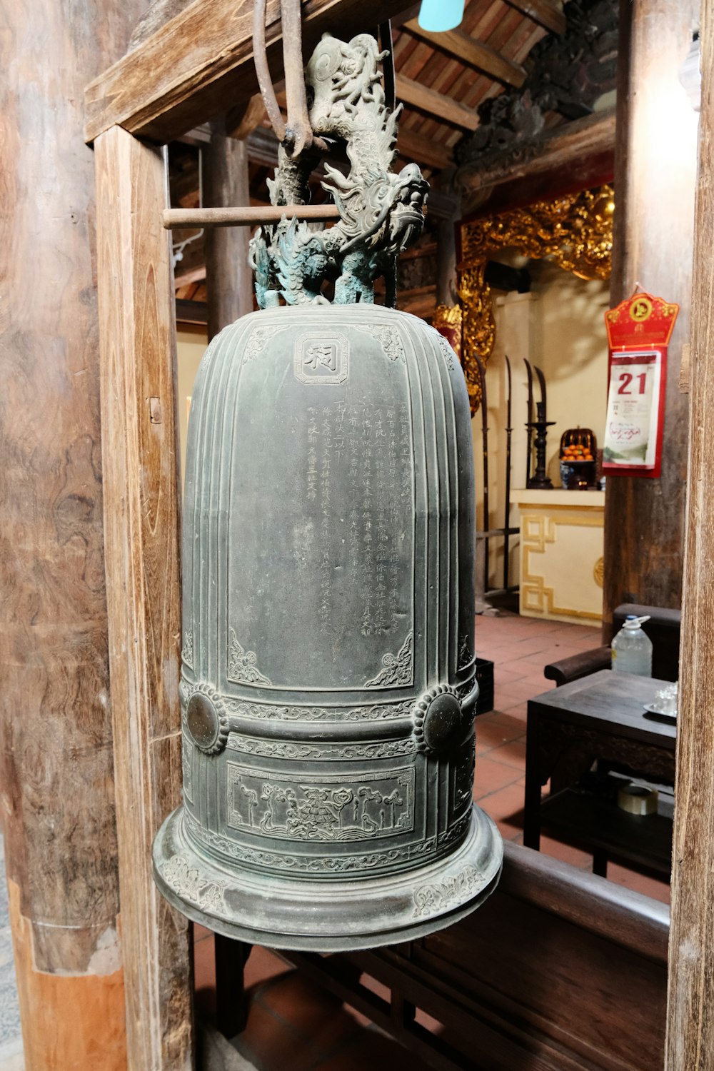 a bell with a statue on top of it