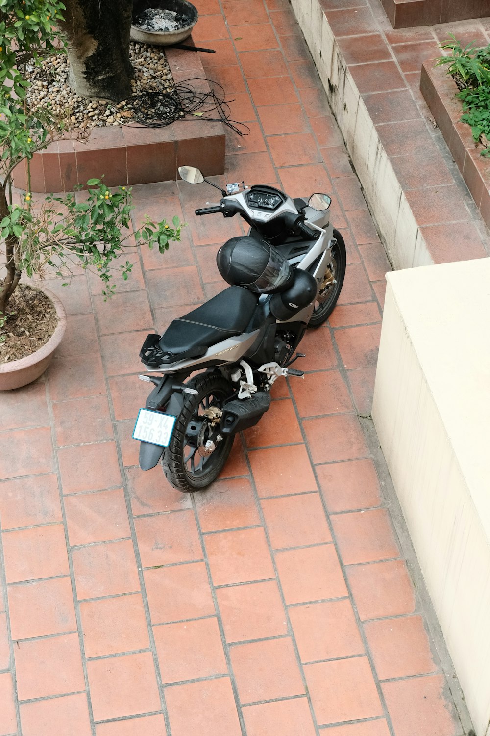 a motorcycle is parked on a brick walkway