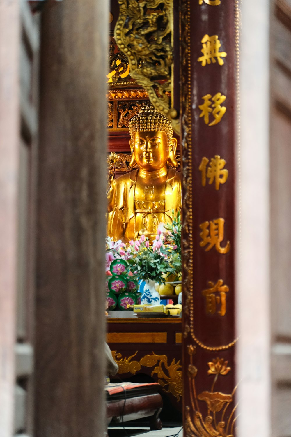 a large golden buddha statue sitting in a room