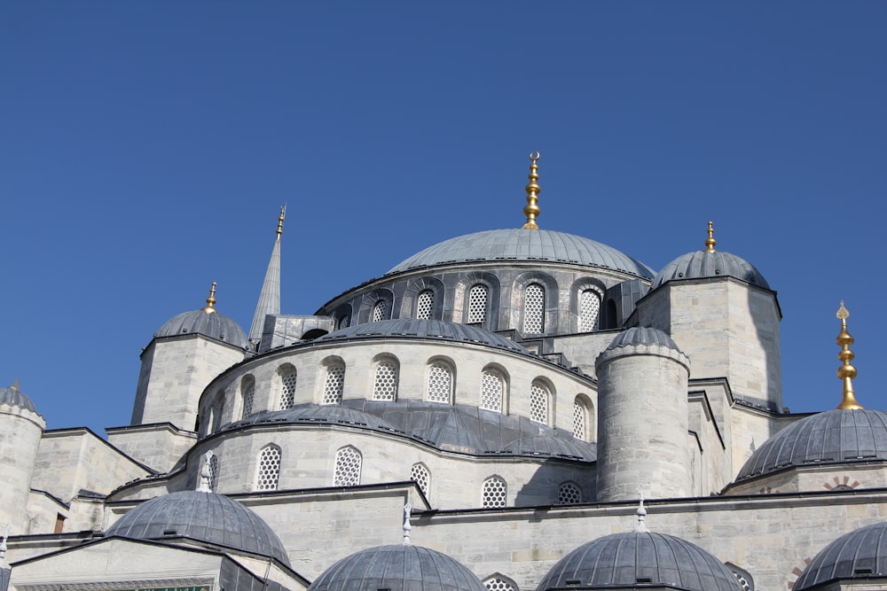 a large gray building with many windows and domes