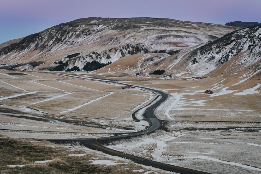 a winding road in the middle of a mountain range