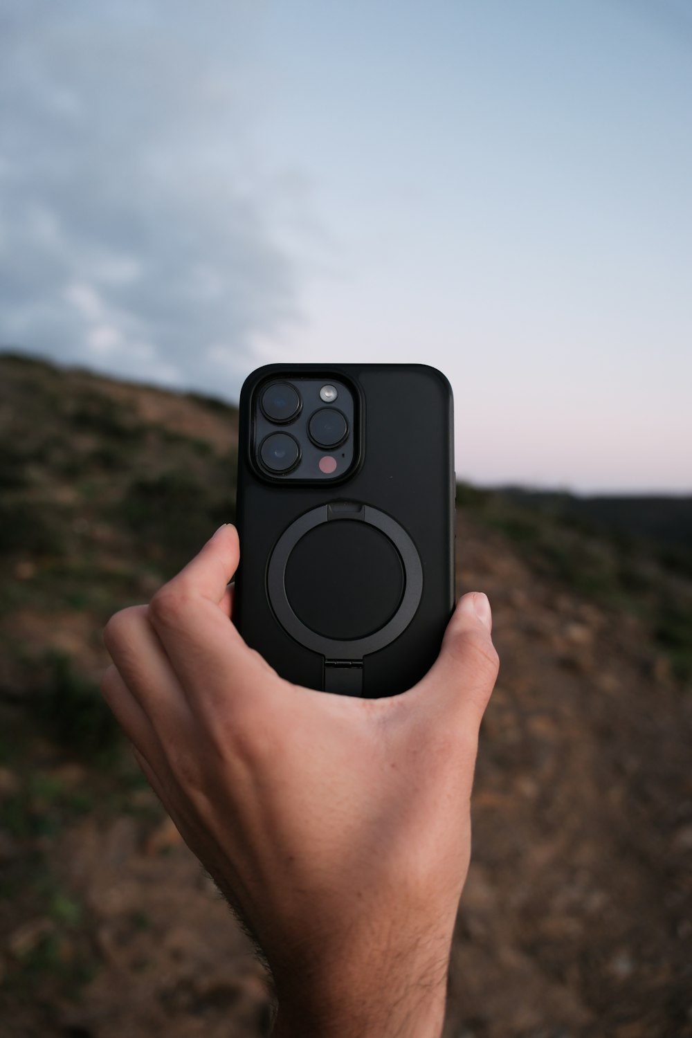 a person holding a cell phone in their hand