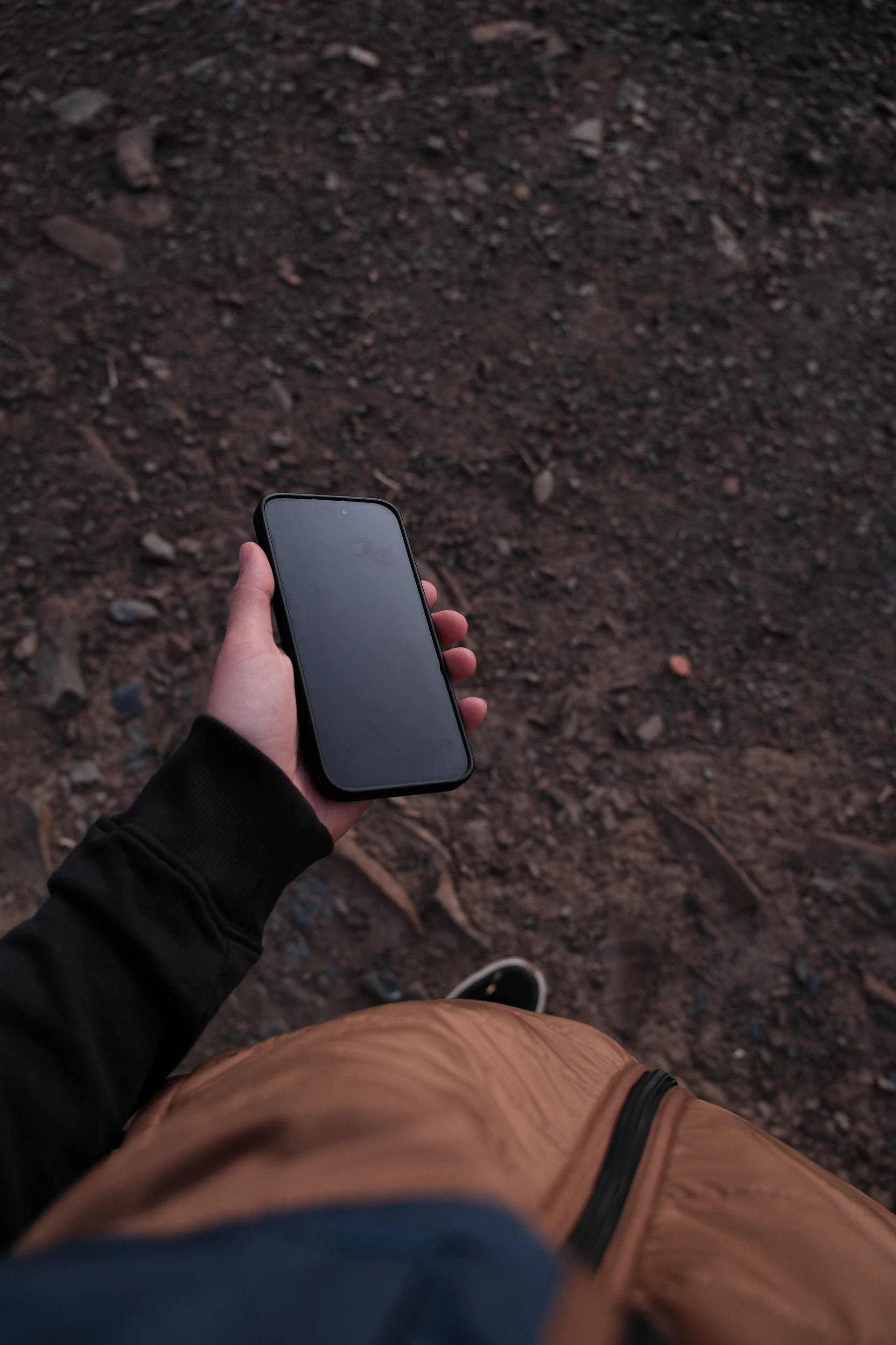 a person holding a cell phone in their hand