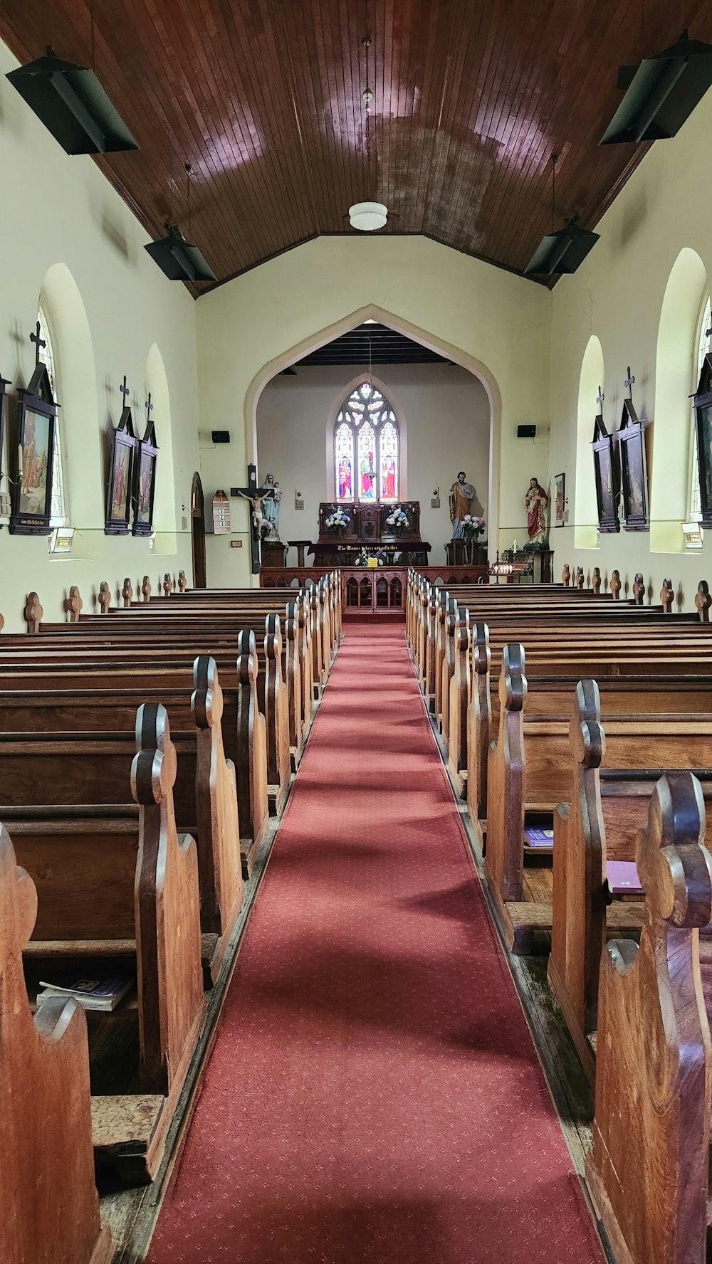a church filled with wooden pews and red carpet