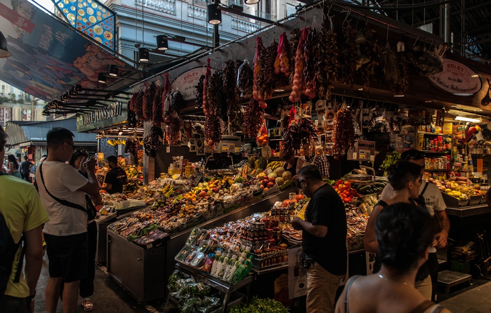 a group of people standing around a market