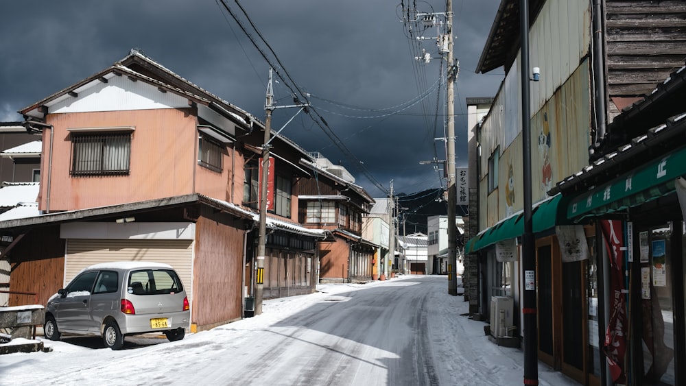 a car is parked on a snowy street