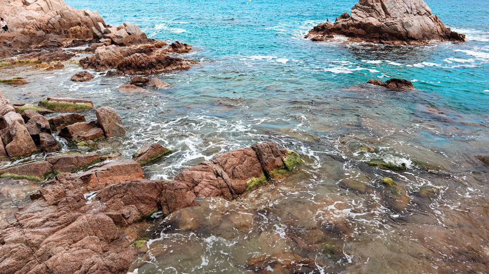 a large body of water surrounded by rocks