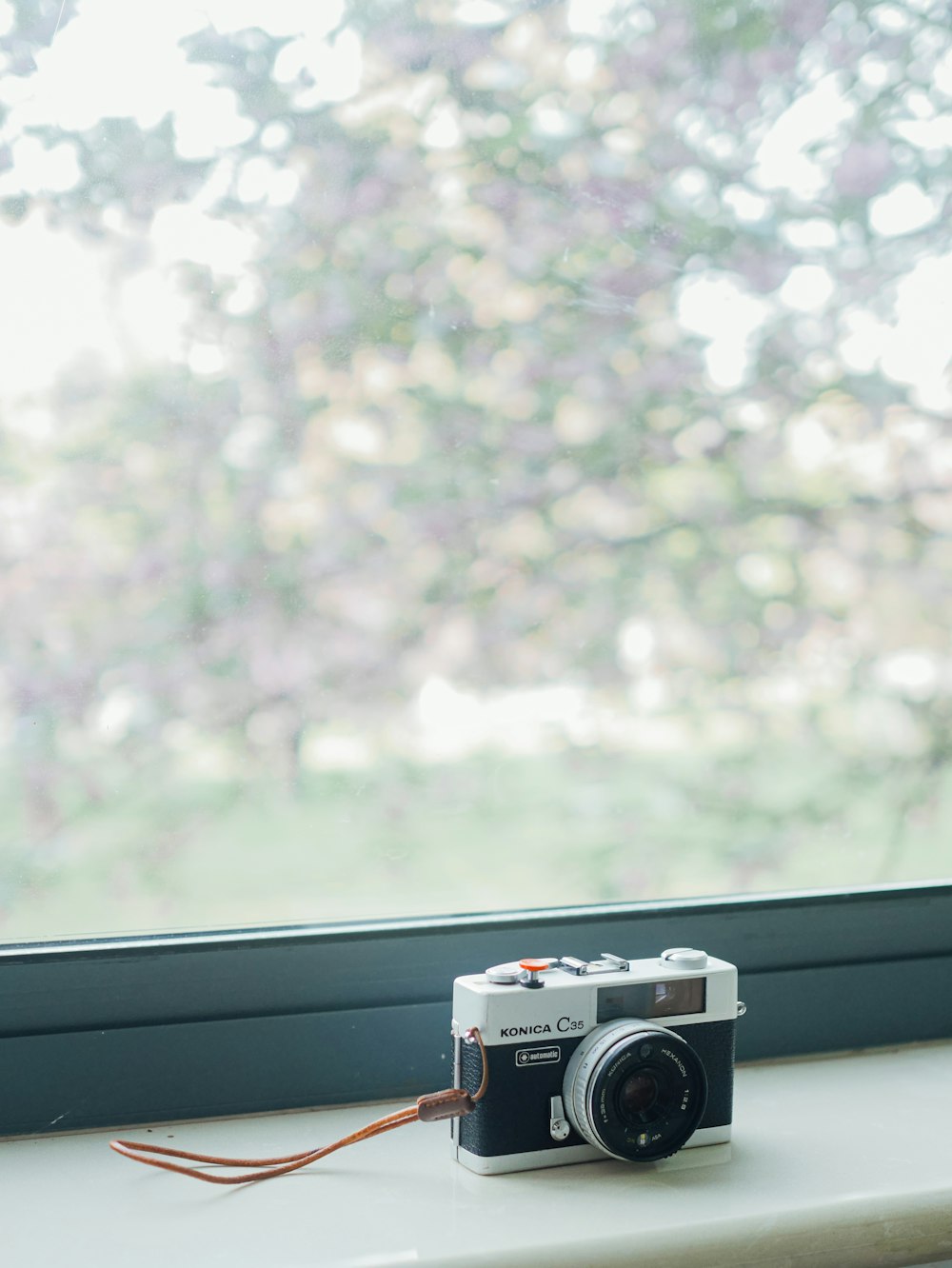 a camera sitting on top of a window sill