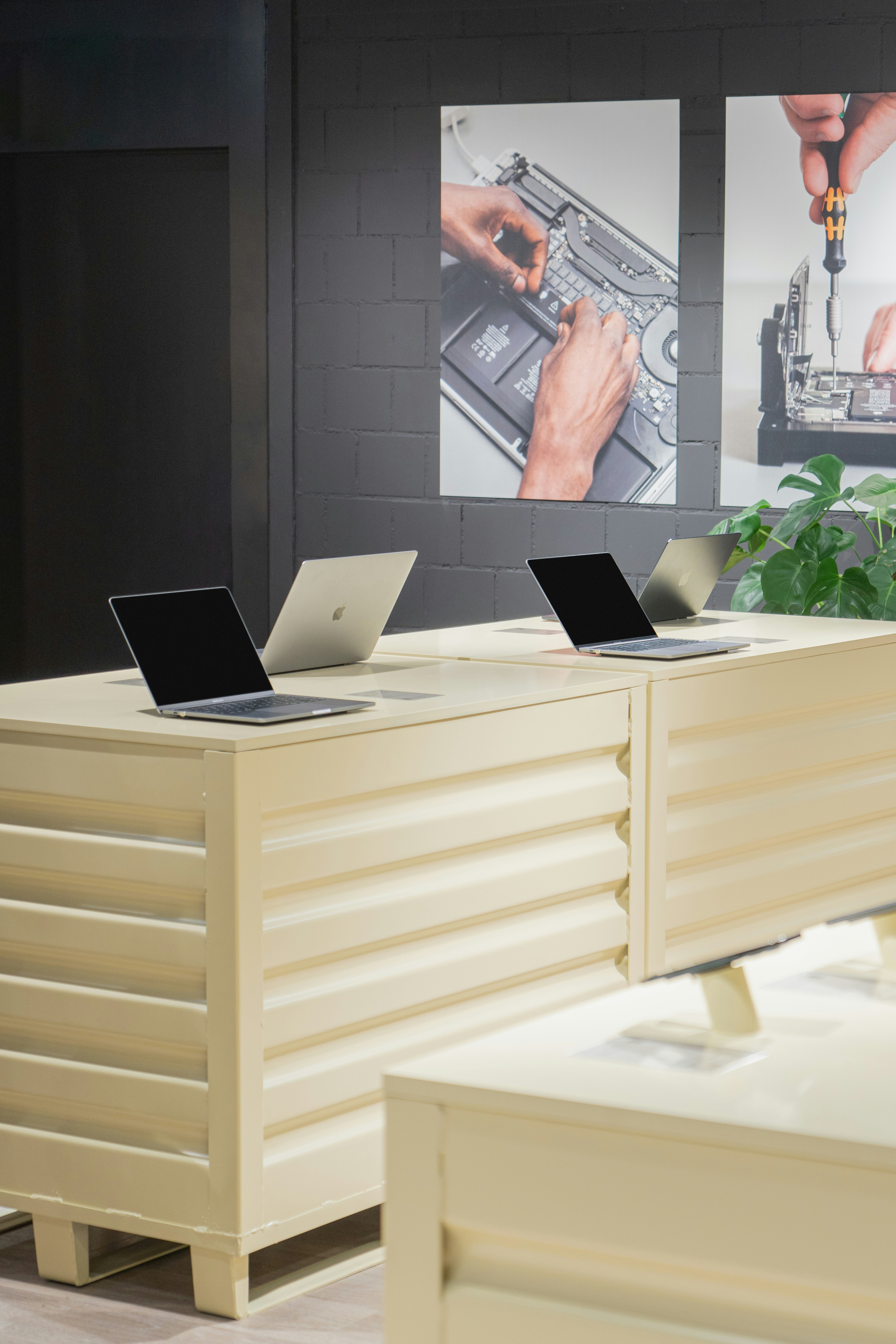 a couple of laptops sitting on top of a desk