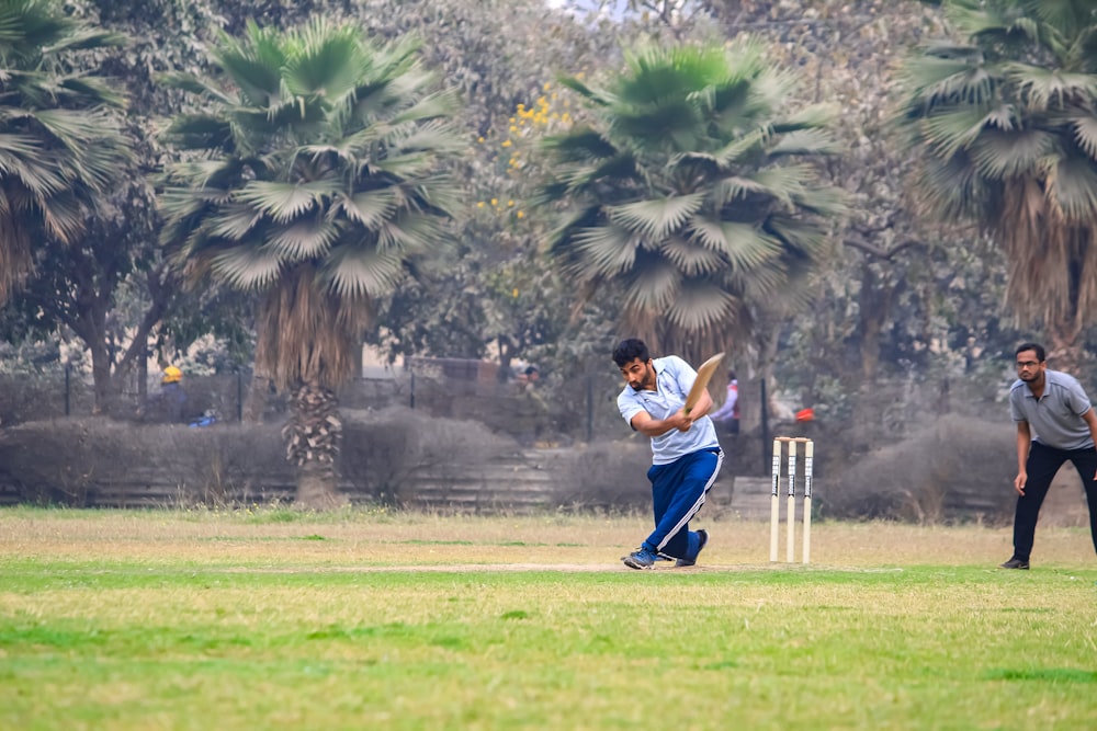 a man playing a game of cricket on a field