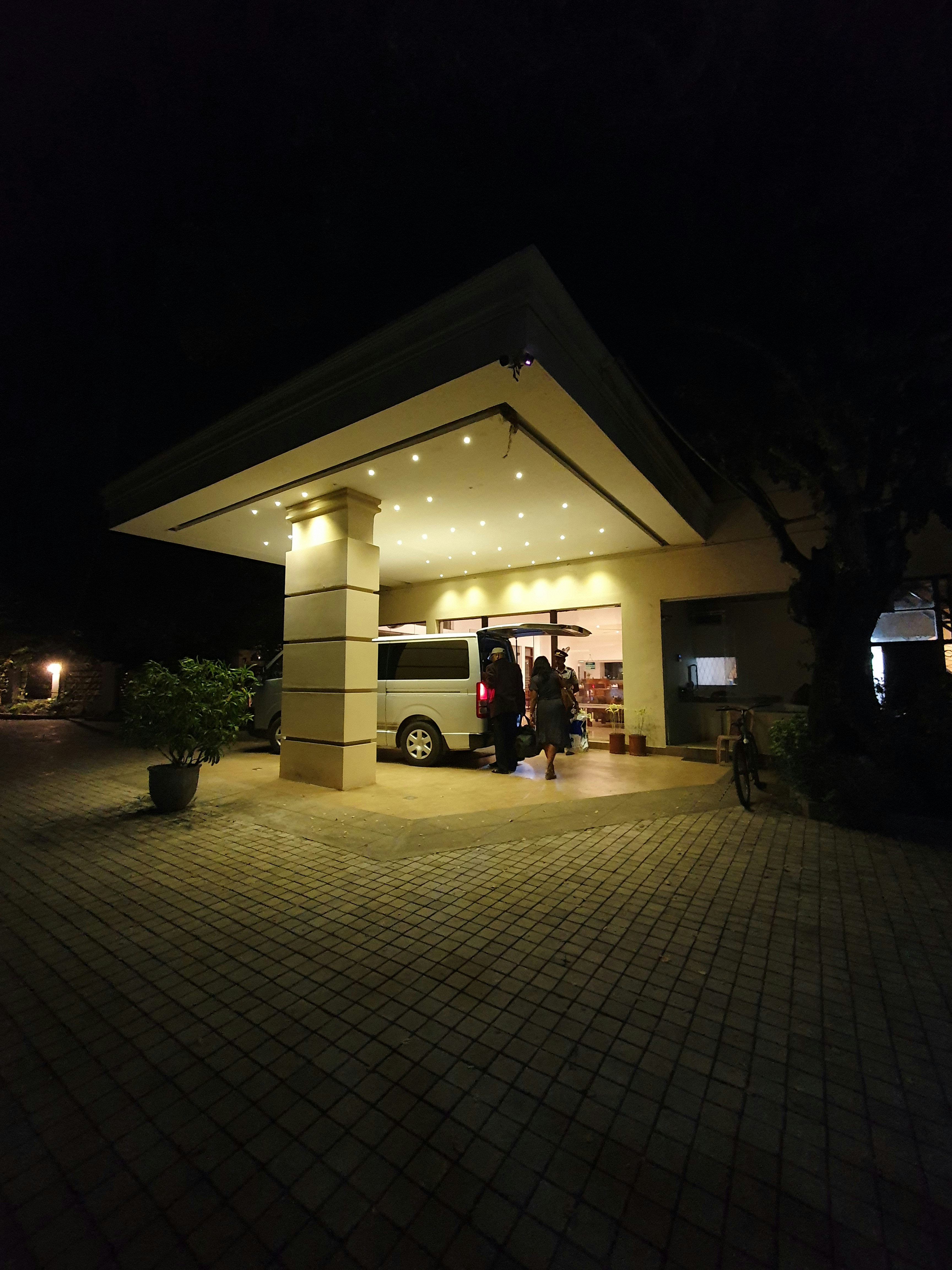 a bus parked in front of a building at night