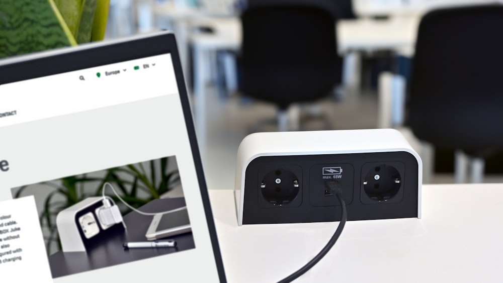 a laptop computer sitting on top of a white desk