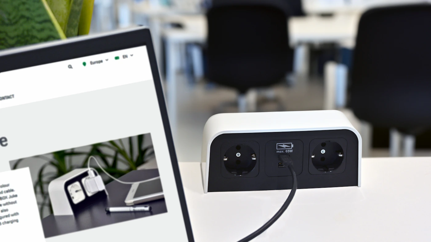 Laptop and desktop USB charging accessory on a clean workspace desk