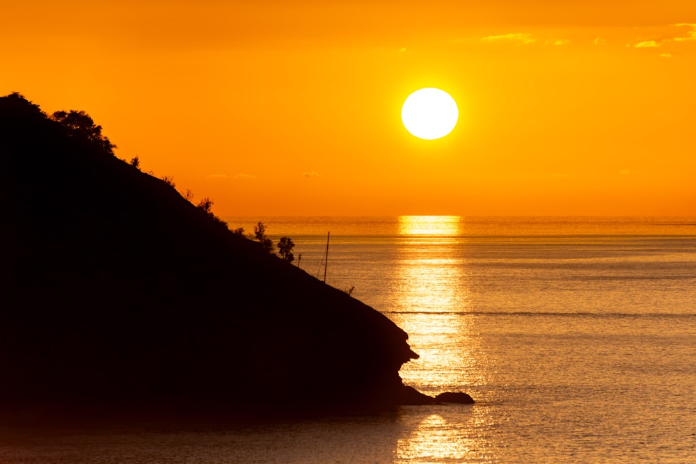 the sun is setting over a body of water