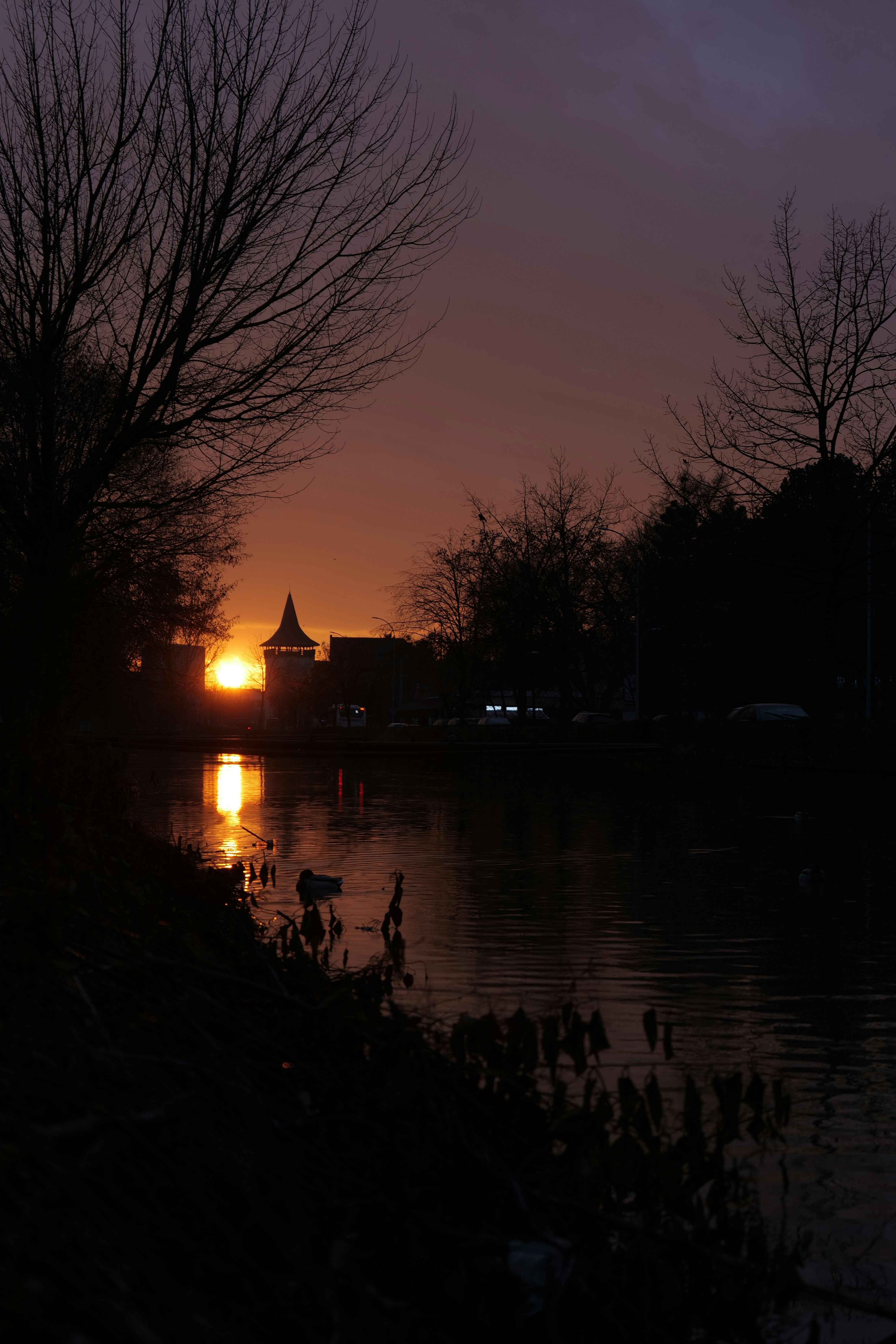 the sun is setting over a body of water