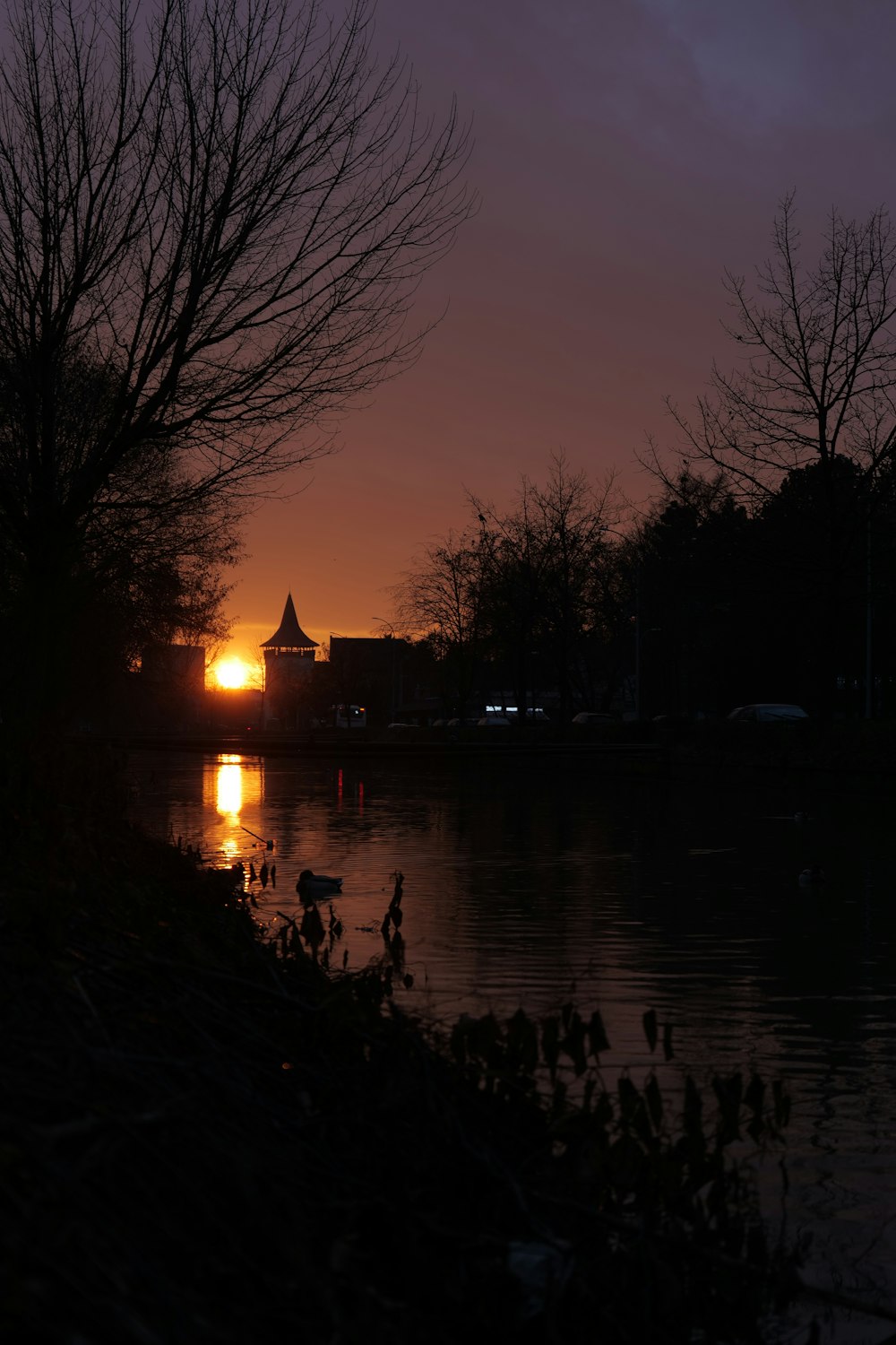 the sun is setting over a body of water