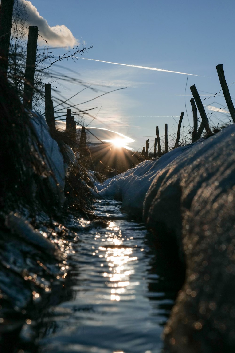 the sun is shining over a body of water