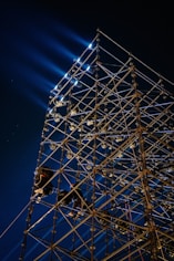 a large metal structure with lights on top of it