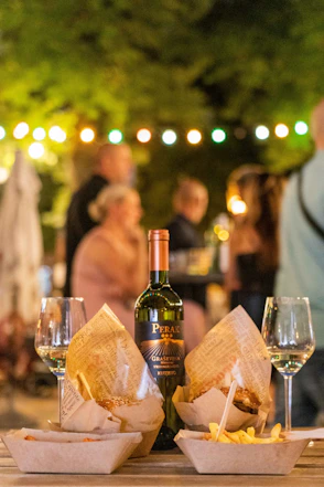 a bottle of wine sitting on top of a wooden table