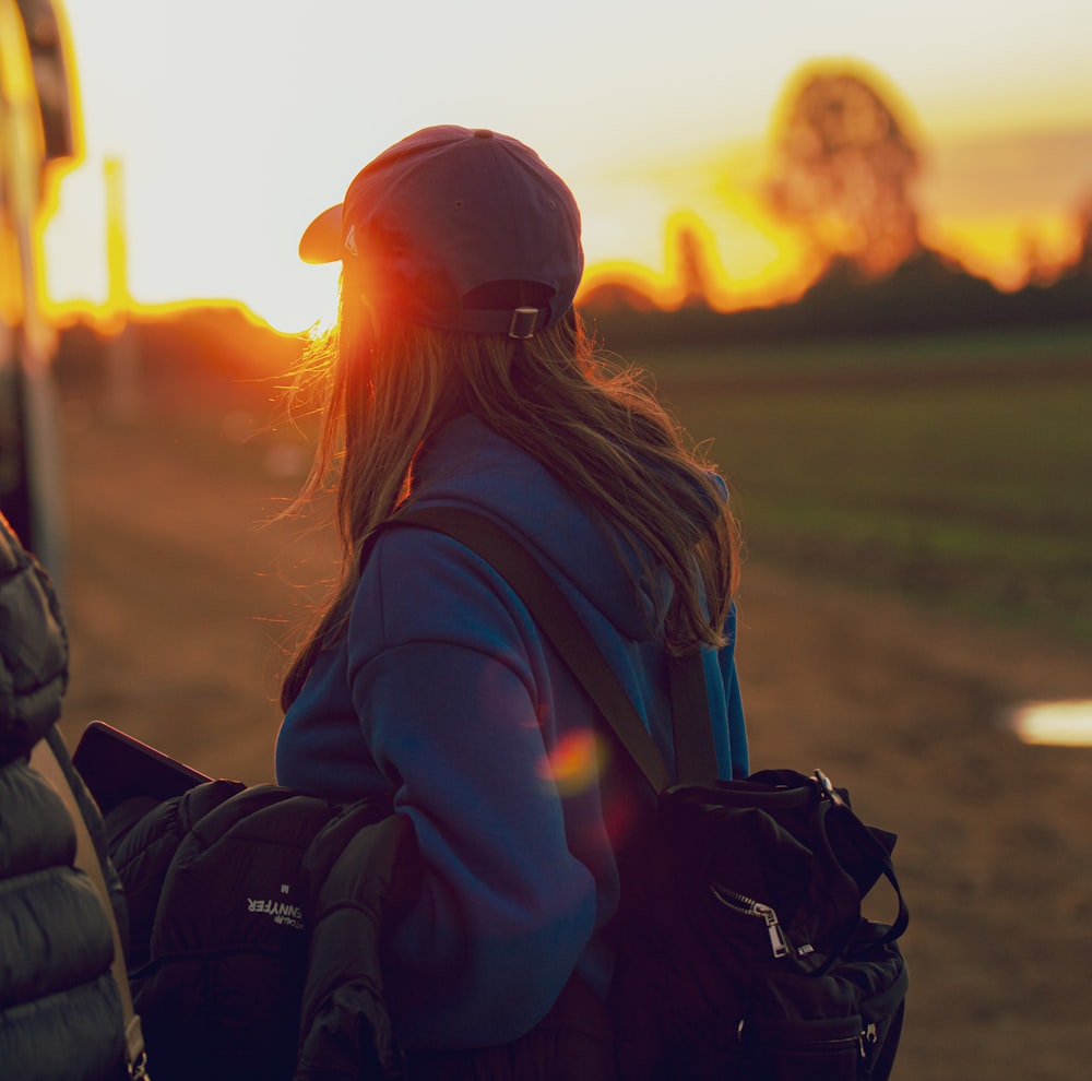 a person with a hat and a backpack