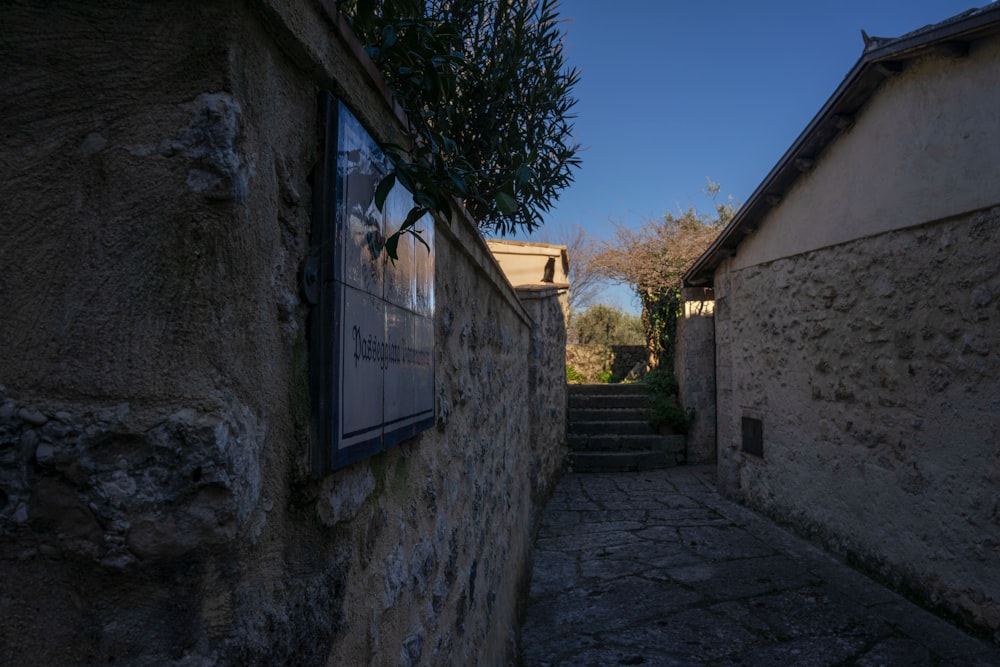 a narrow alley with stone walls and steps
