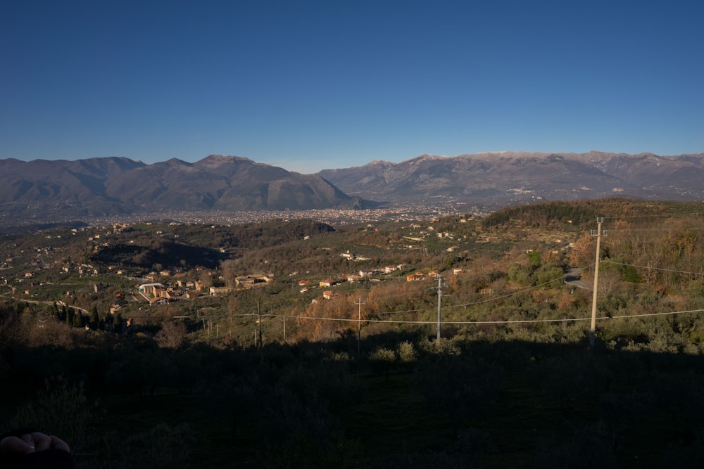 a view of a valley with mountains in the background