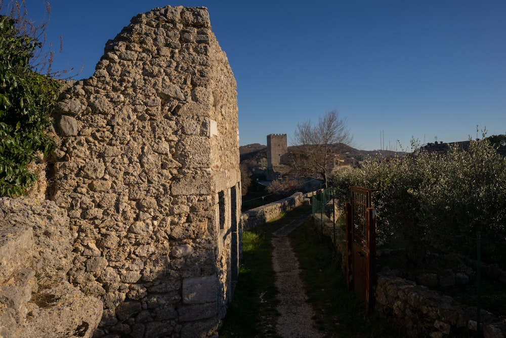 an old stone building with a path between it