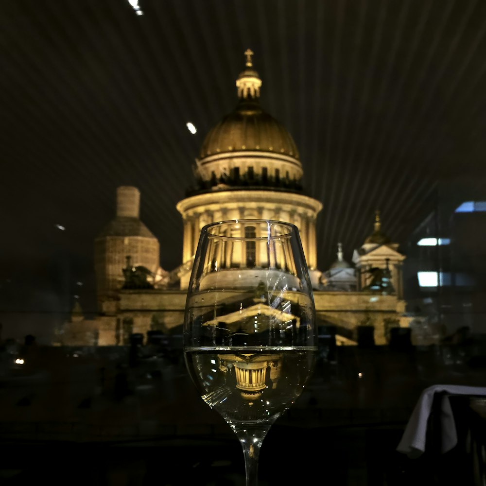 a glass of wine sitting on top of a table