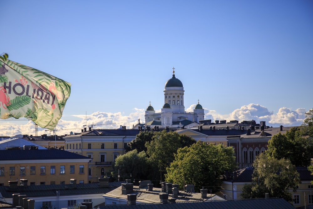 a flag flying in the air over a city